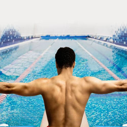 man preparing to swim indoors